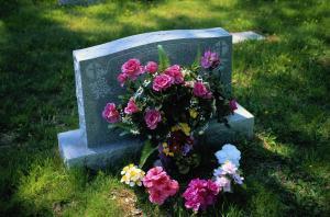 purple flowers at headstone